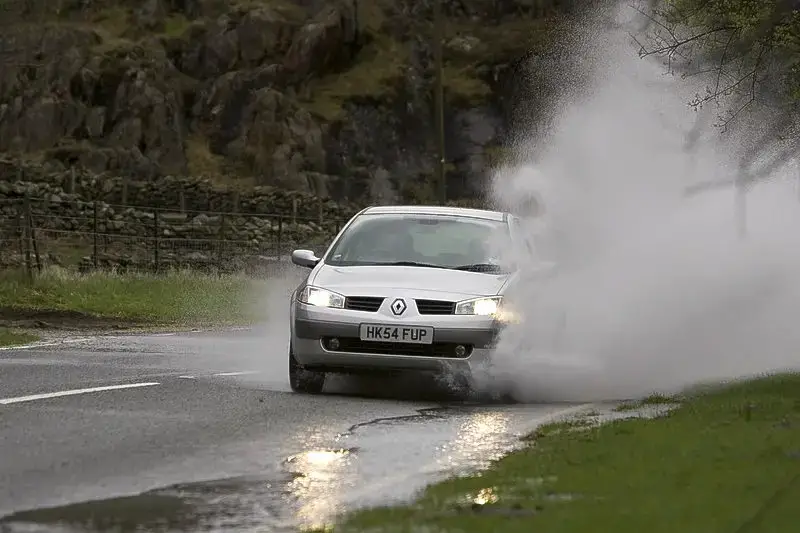 Close-up of a car splashing water